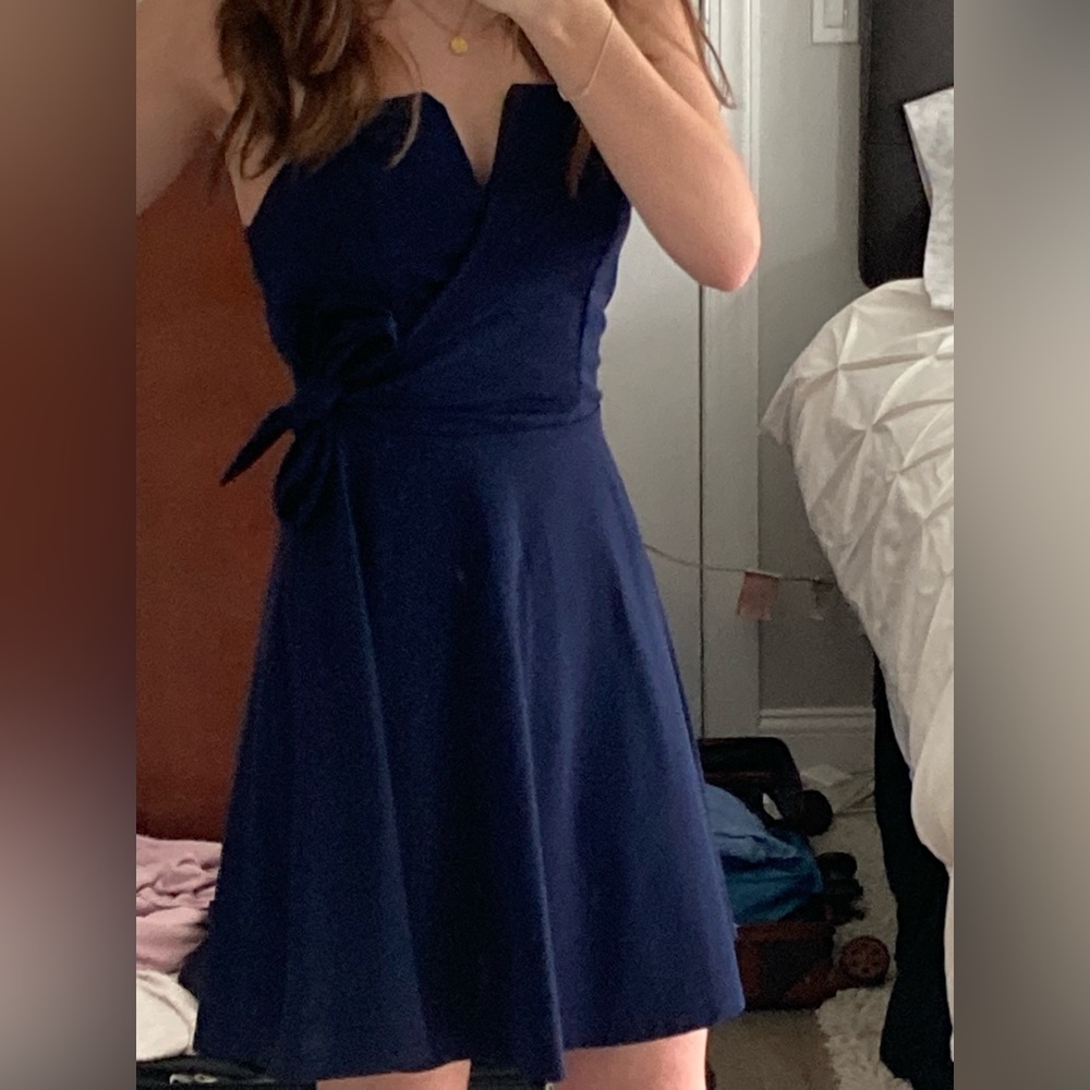 This is a strapless navy dress, with a bow ribbon on the waist.